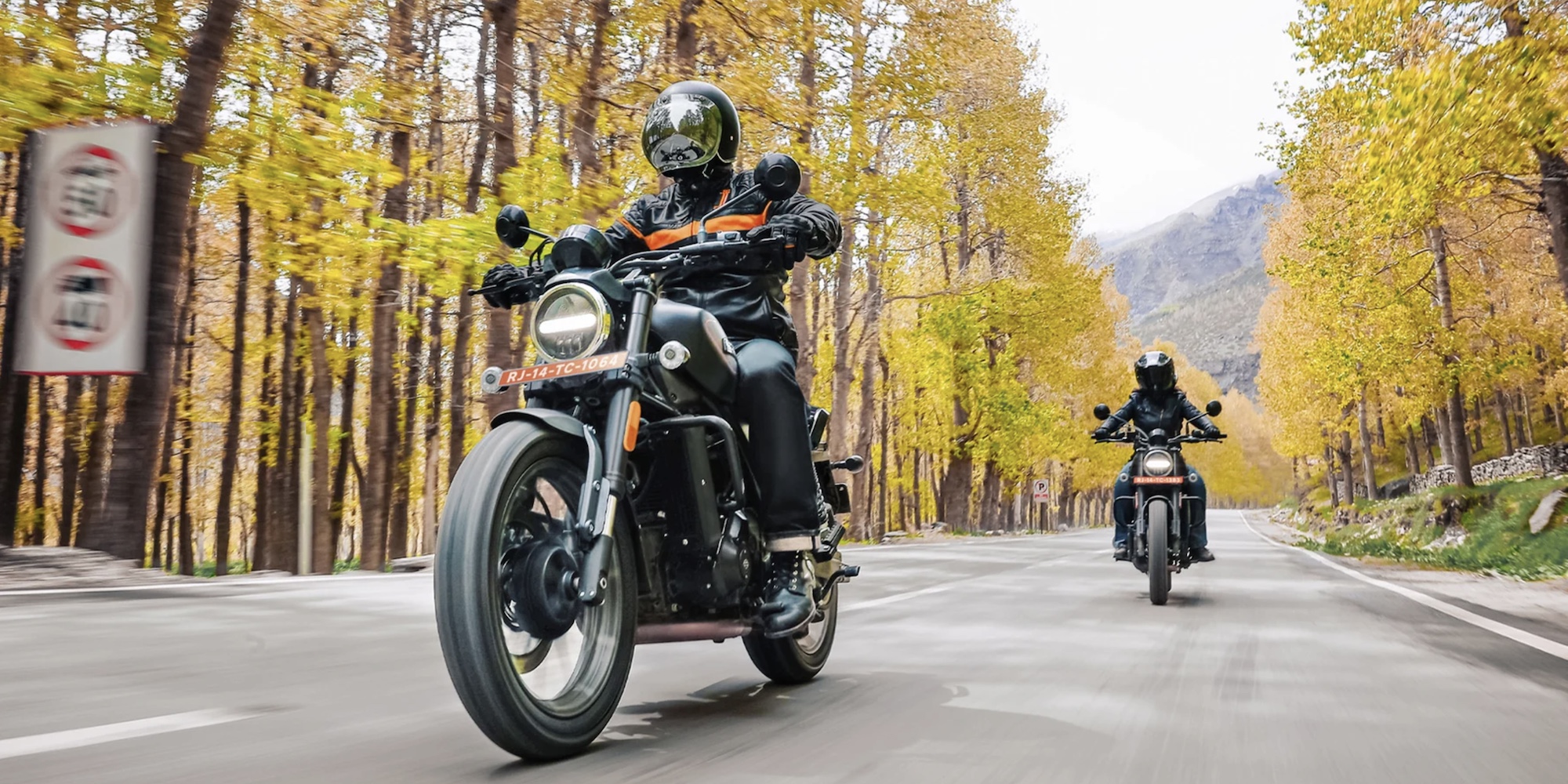 Motorcyclists enjoying a beginner-friendly bike in nature.