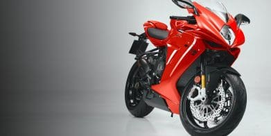 A side quarter view of a red, supersport motorcycle.