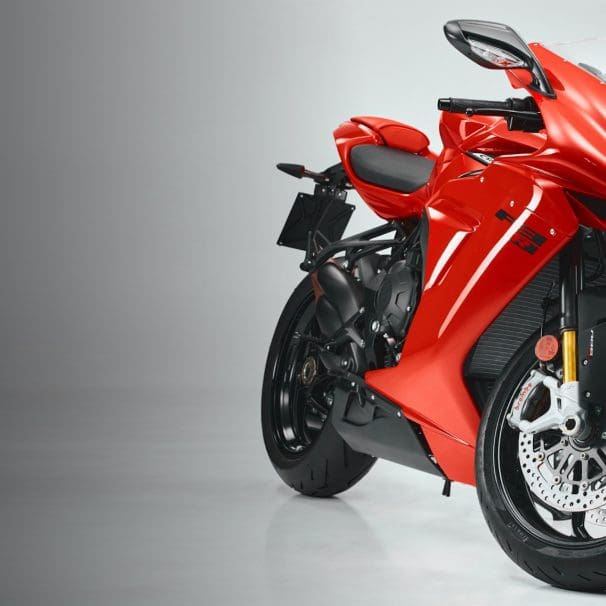 A side quarter view of a red, supersport motorcycle.