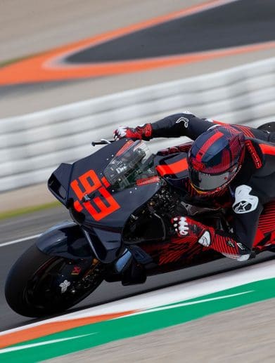 A front view of a MotoGP rider on a race track.