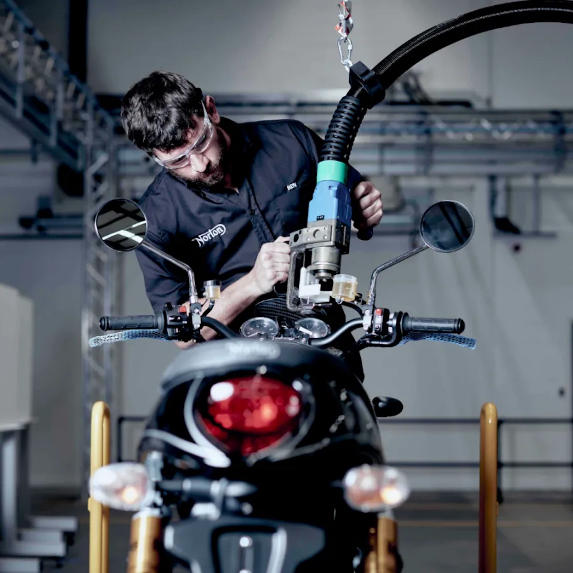 A mechanic working on a motorcycle.