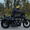 Devan pushing a motorcycle while wearing the Defender Motorcycle Hoodie