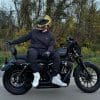 Devan wearing the Akin Moto Defender Motorcycle Hoodie while sitting on a motorcycle