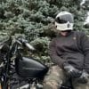 Devan sitting on a Harley wearing the Defender Motorcycle Hoodie