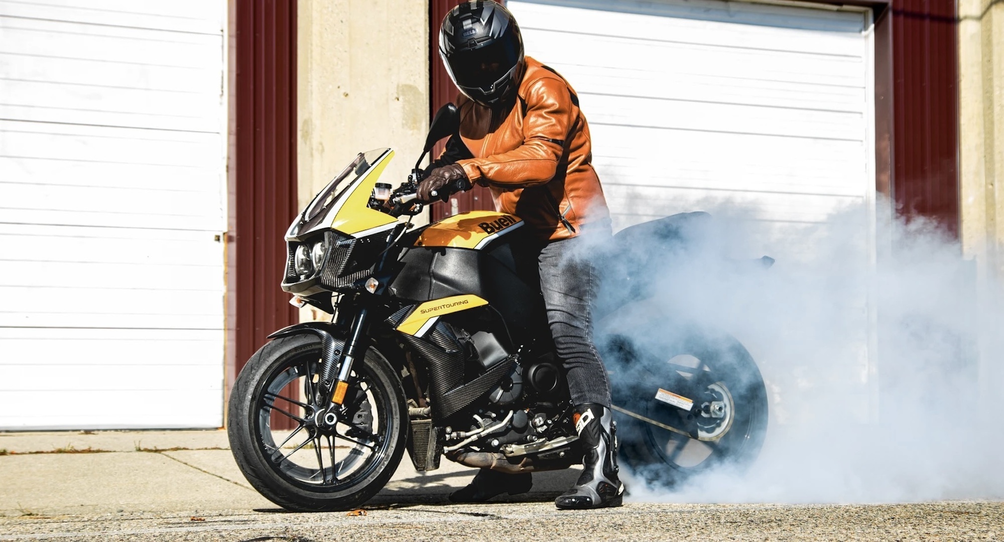 A side view of a guy on a motorcycle.