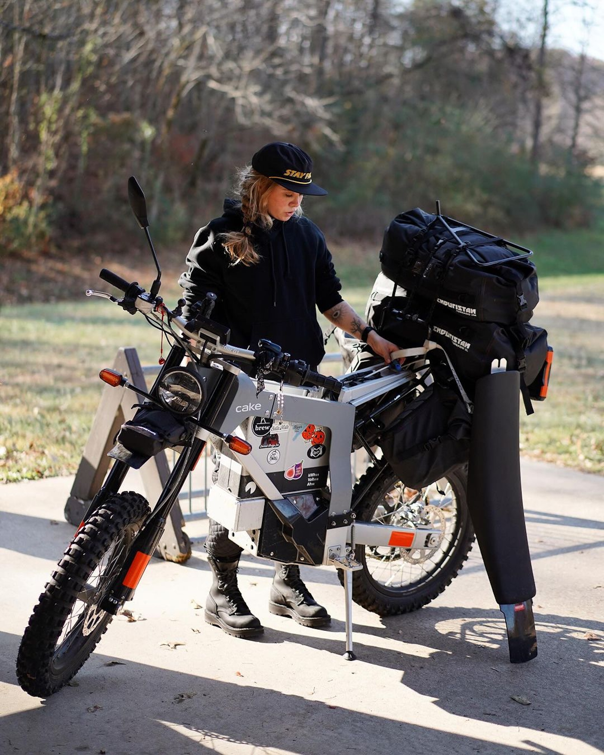 A female rider on an electric motorcycle. 