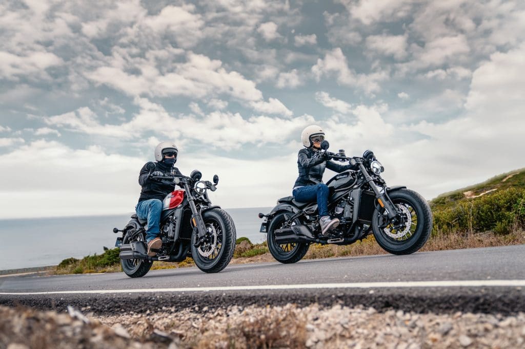 Two riders on cruiser motorcycles.