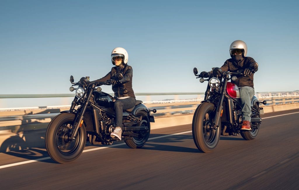 Two riders on cruiser motorcycles.