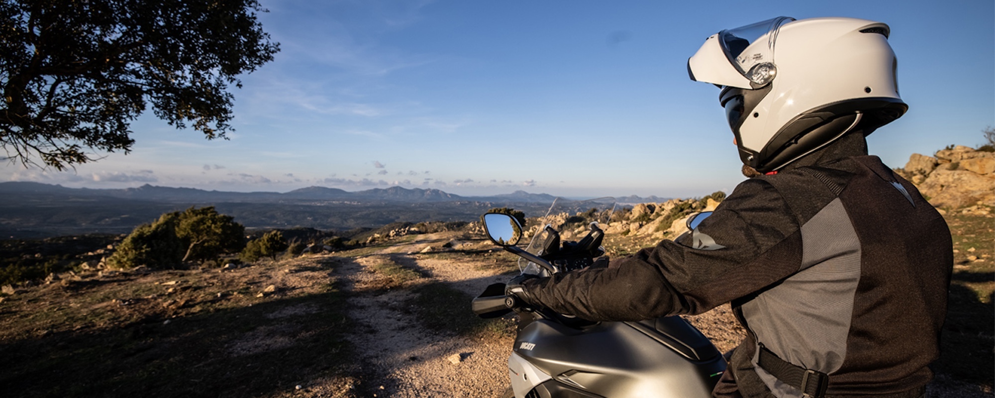 A motorcyclist wearing a helmet on a motorcycle.