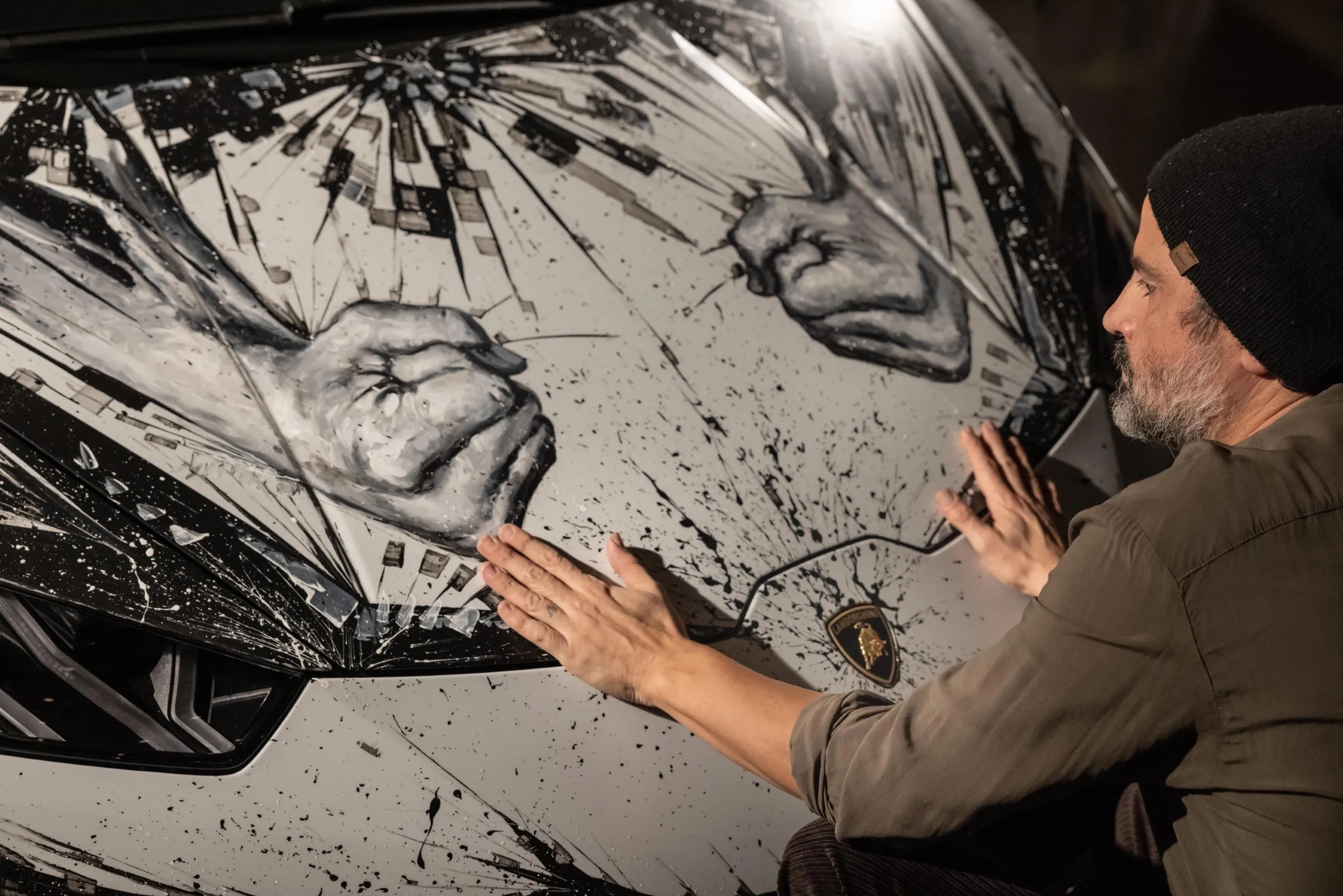 A man with his hands on a custom car. 