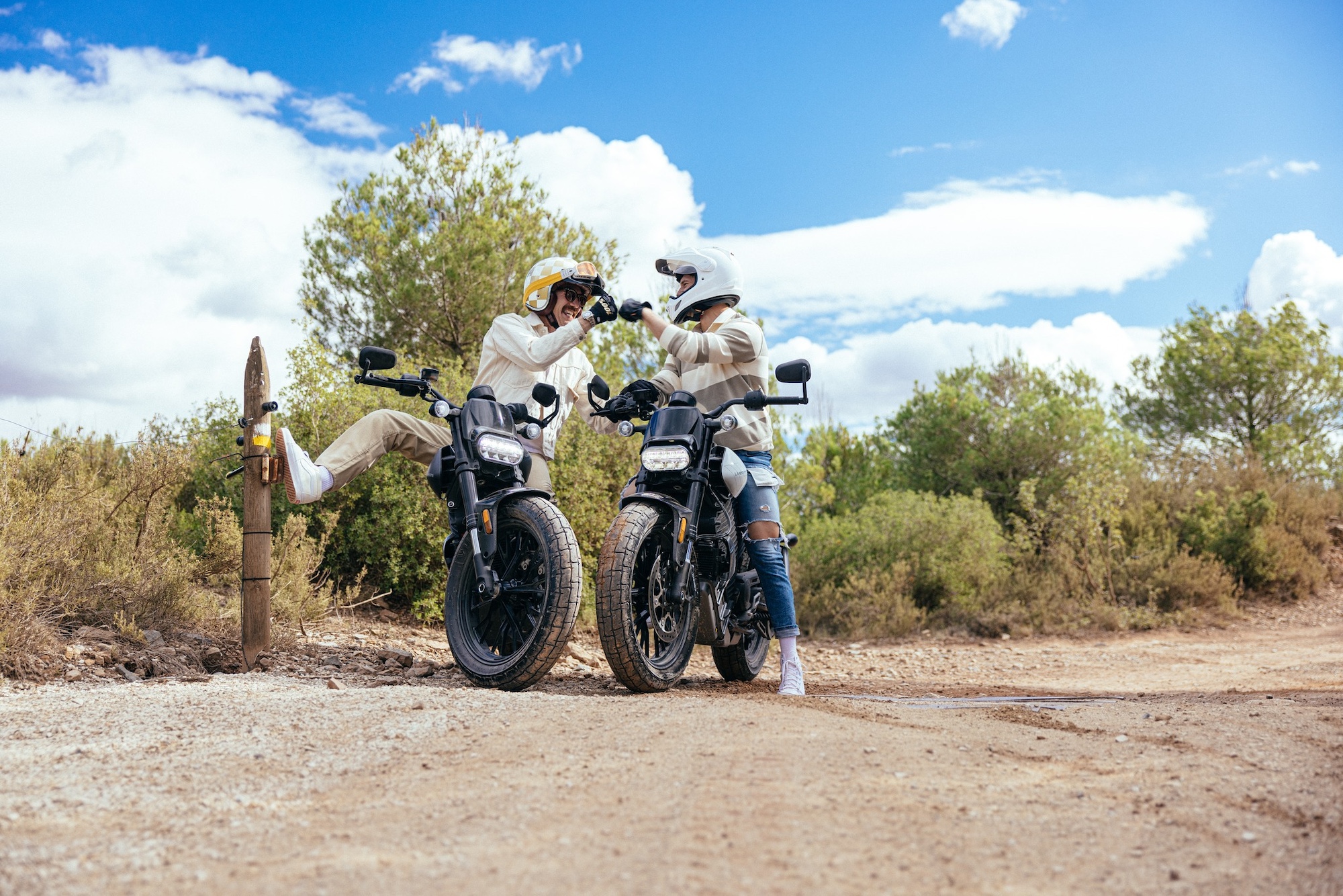 Two riders on electric motorcycles.