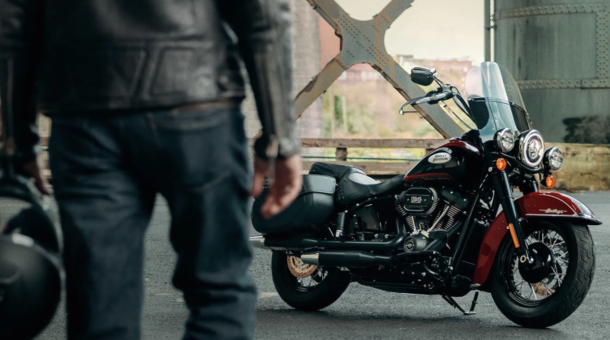 A man walking toward a motorcycle.