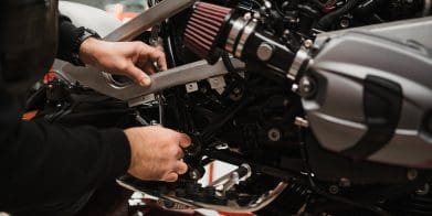 hands working on a motorcycle