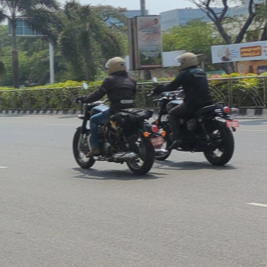 Two riders trying out motorcycles.