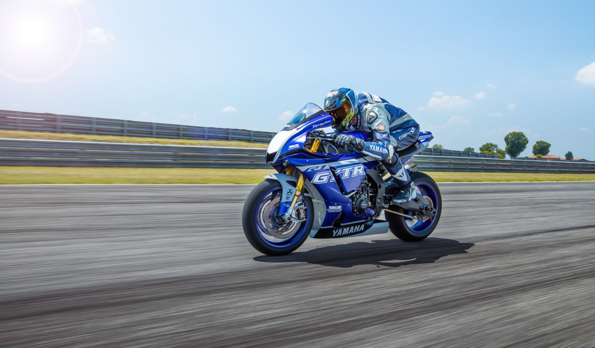 A racing motorcyclist on a track.