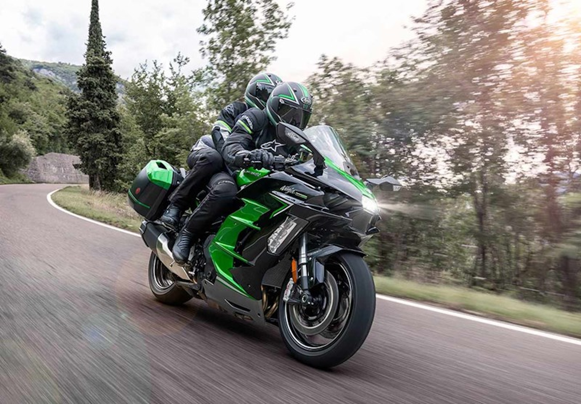 Two riders on a Kawasaki motorcycle.