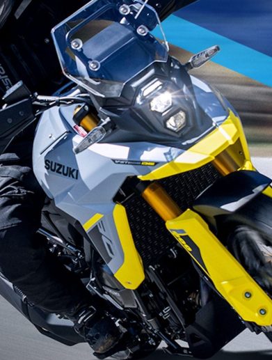 A motorcyclist aboard a Suzuki adventure motorcycle.