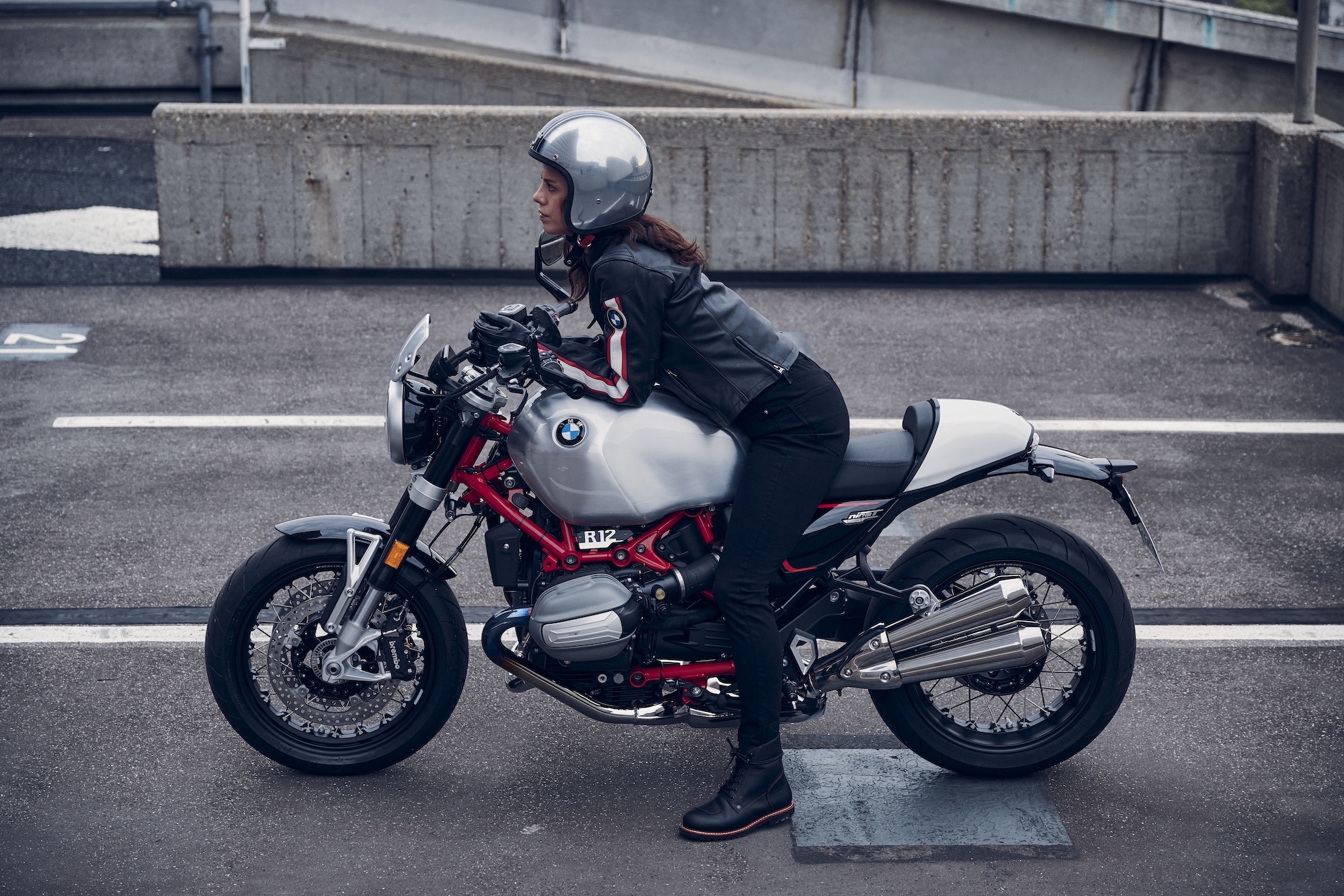 A woman leaning forward on a motorcycle.