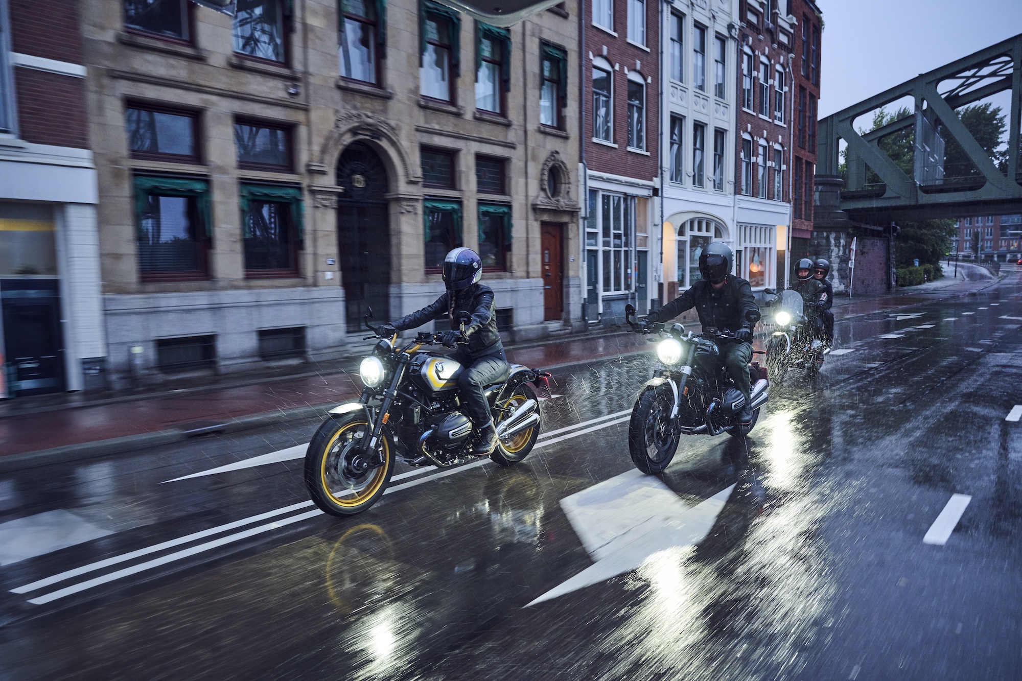 Three motorcyclists in the rain.