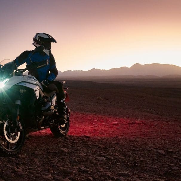 A rider on a BMW R 1300 GS in the desert.