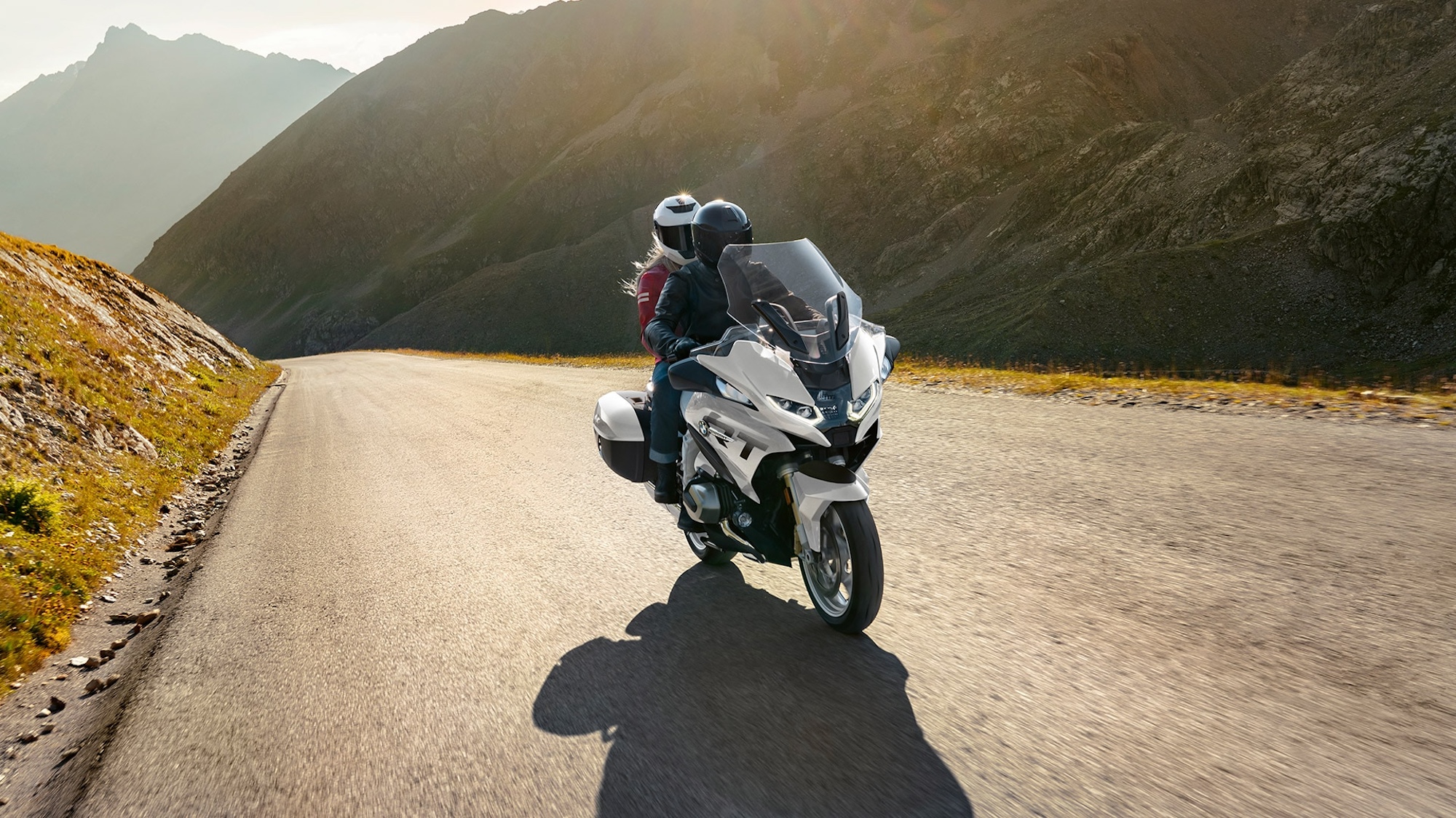 A motorcyclist riding at sunset.