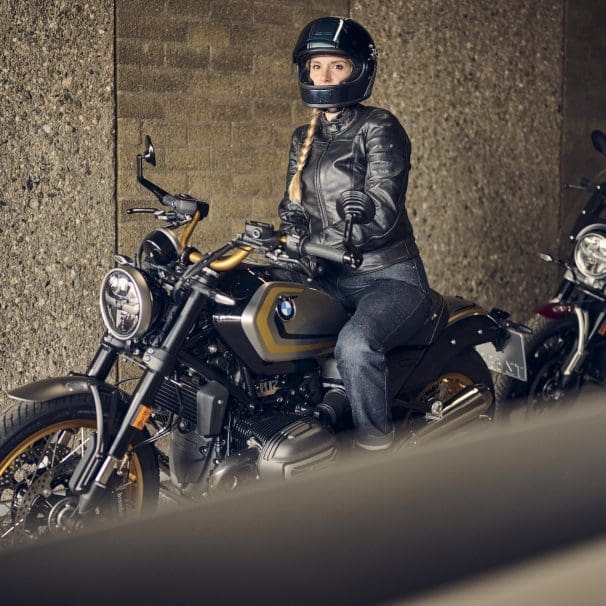 A woman sitting on a motorcycle.