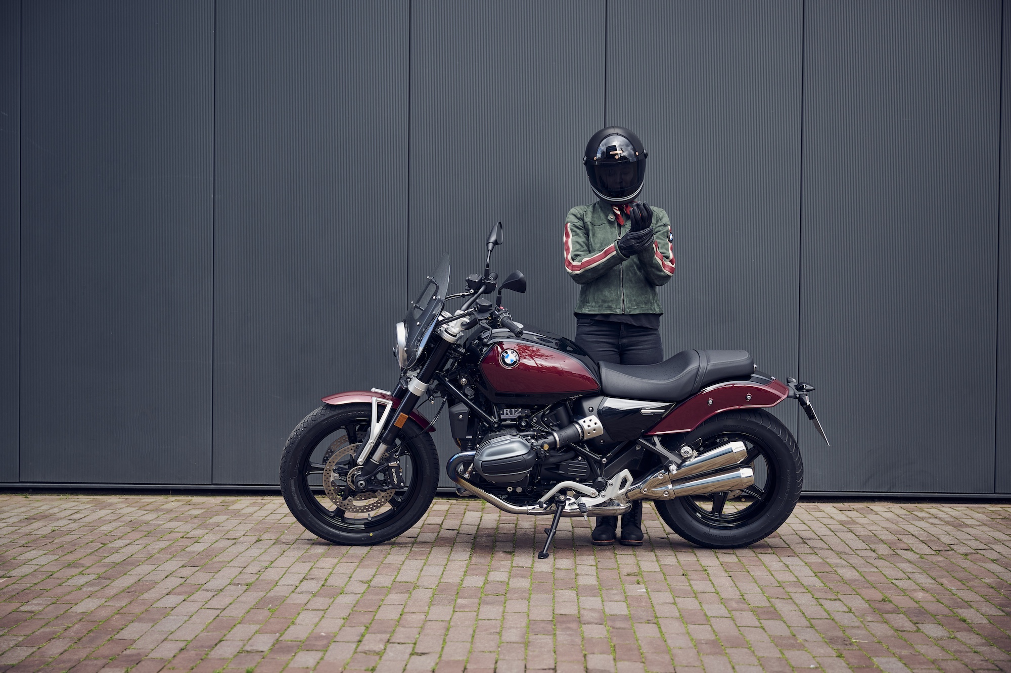 A man standing behind a motorcycle.