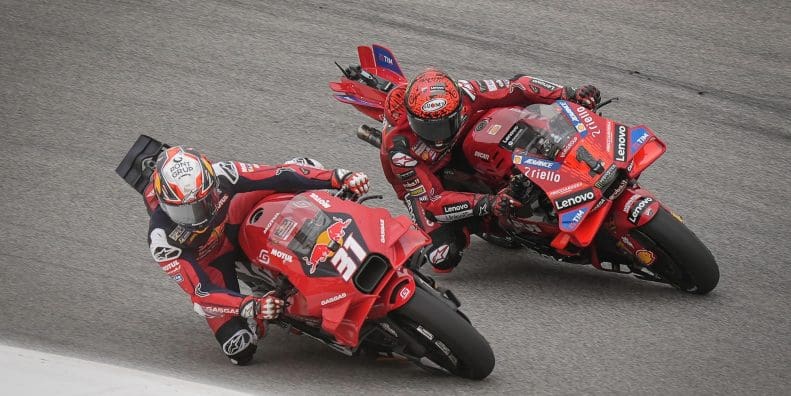 Two racers on the MotoGP circuit.