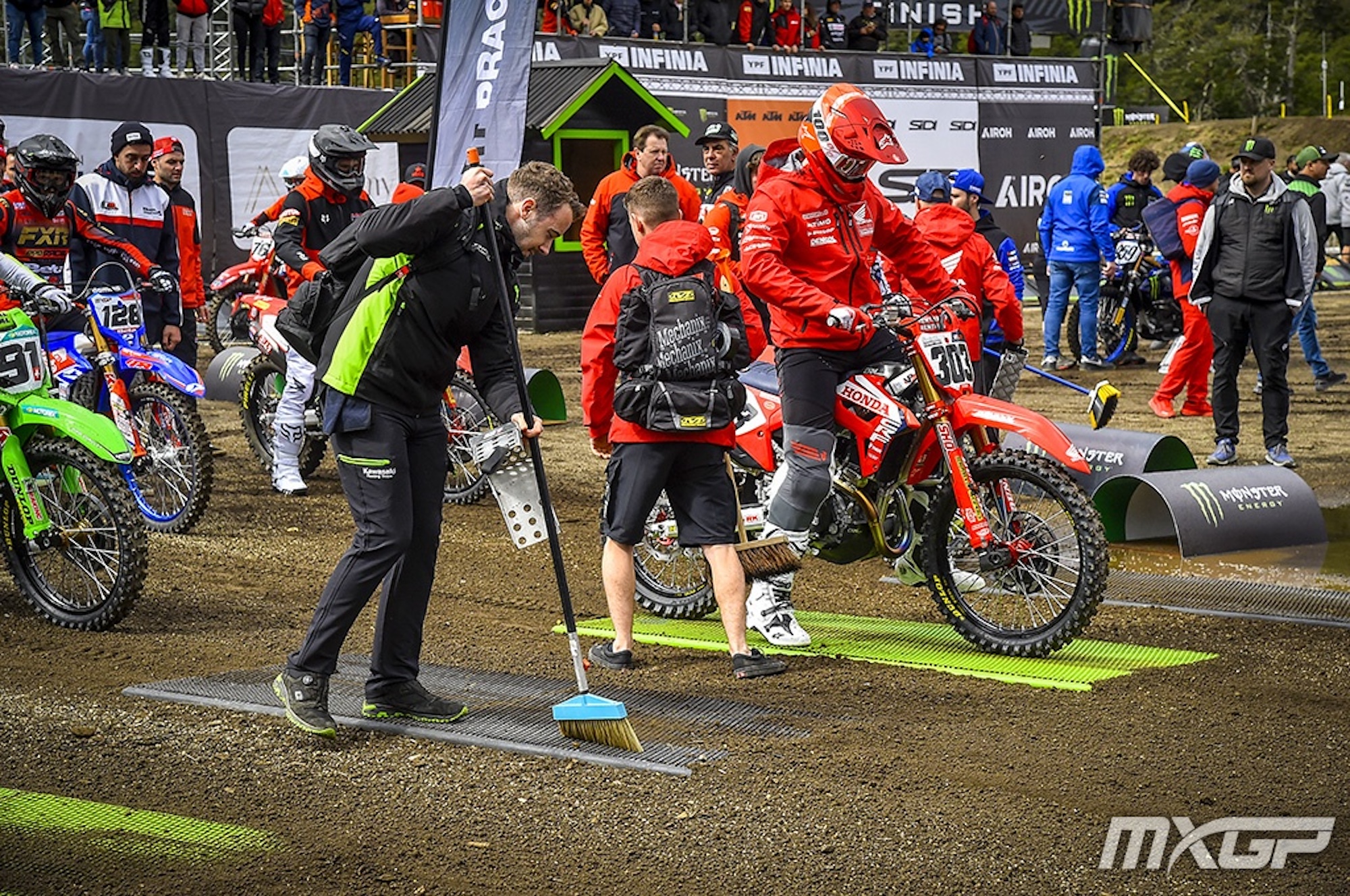 Motorcyclists getting read to race.