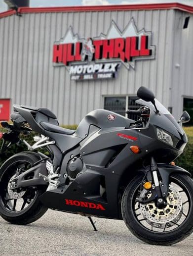 A Honda motorcycle in front of a dealership.