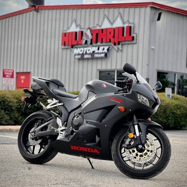 A Honda motorcycle in front of a dealership.