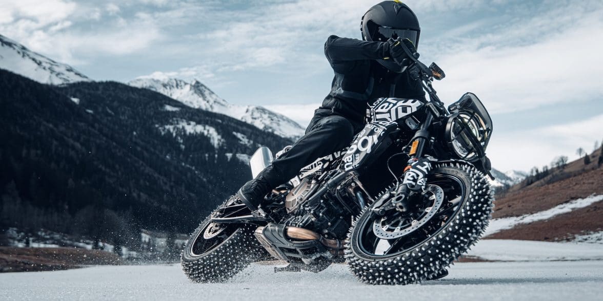A motorcyclist with studded tired on ice.