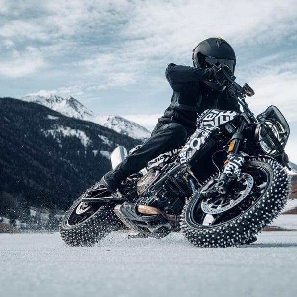 A motorcyclist with studded tired on ice.