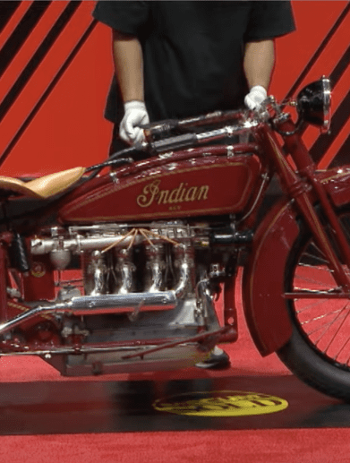 A side view of an antique motorcycle.