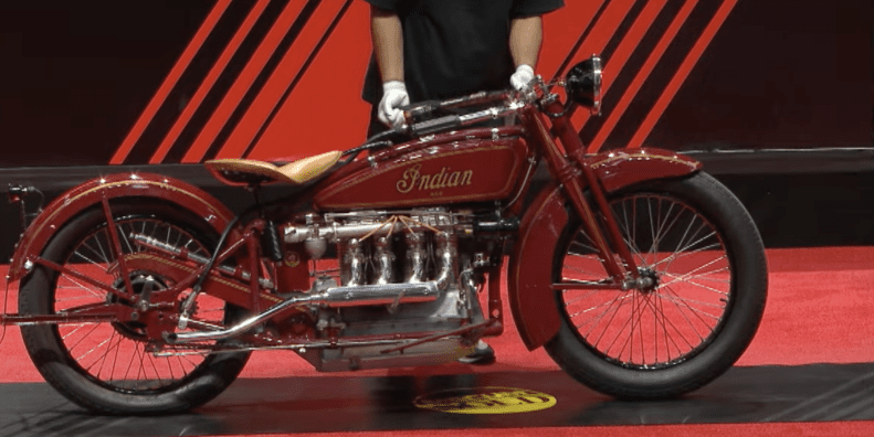 A side view of an antique motorcycle.