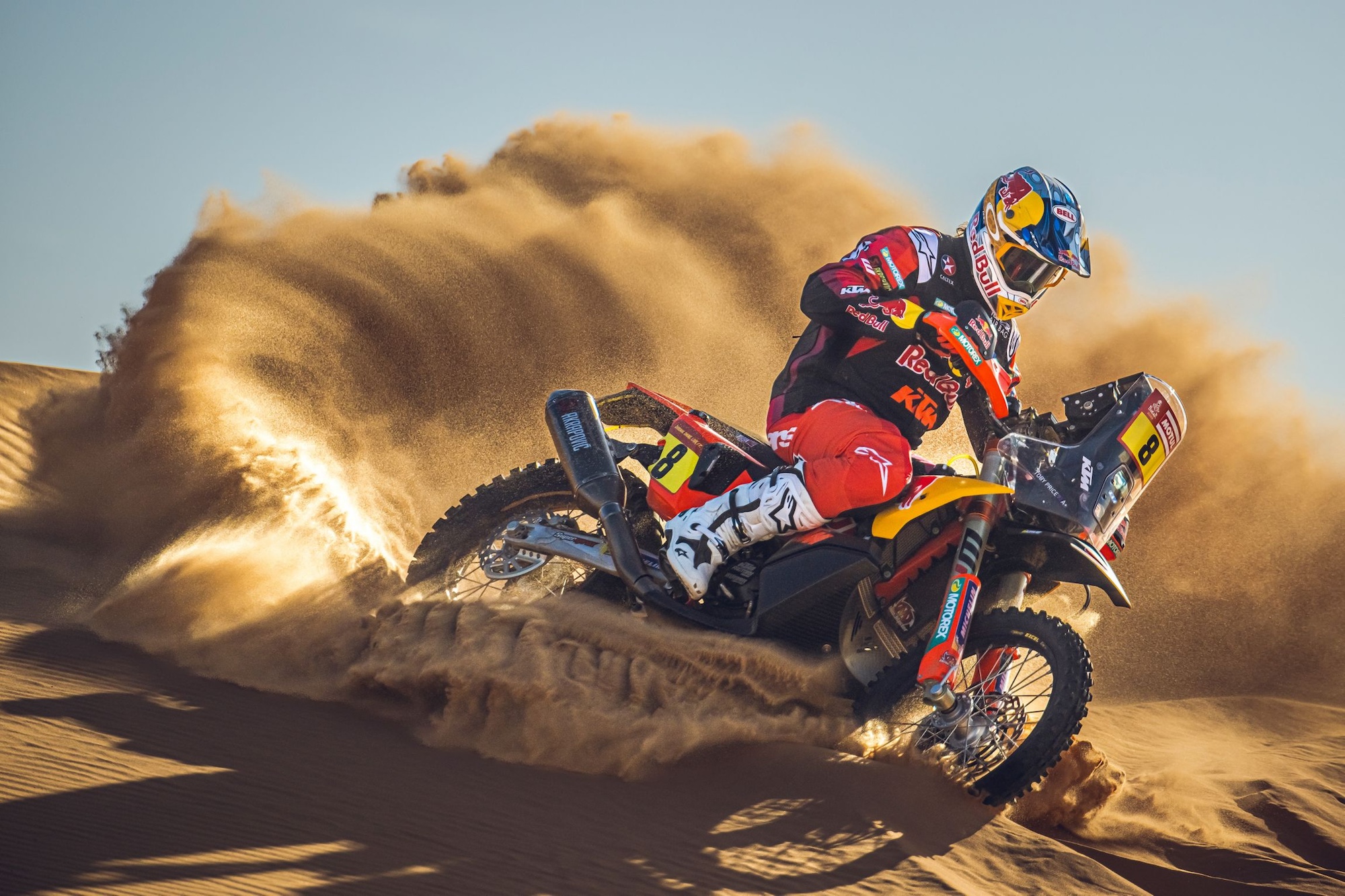 A rally racer in the sand dunes.