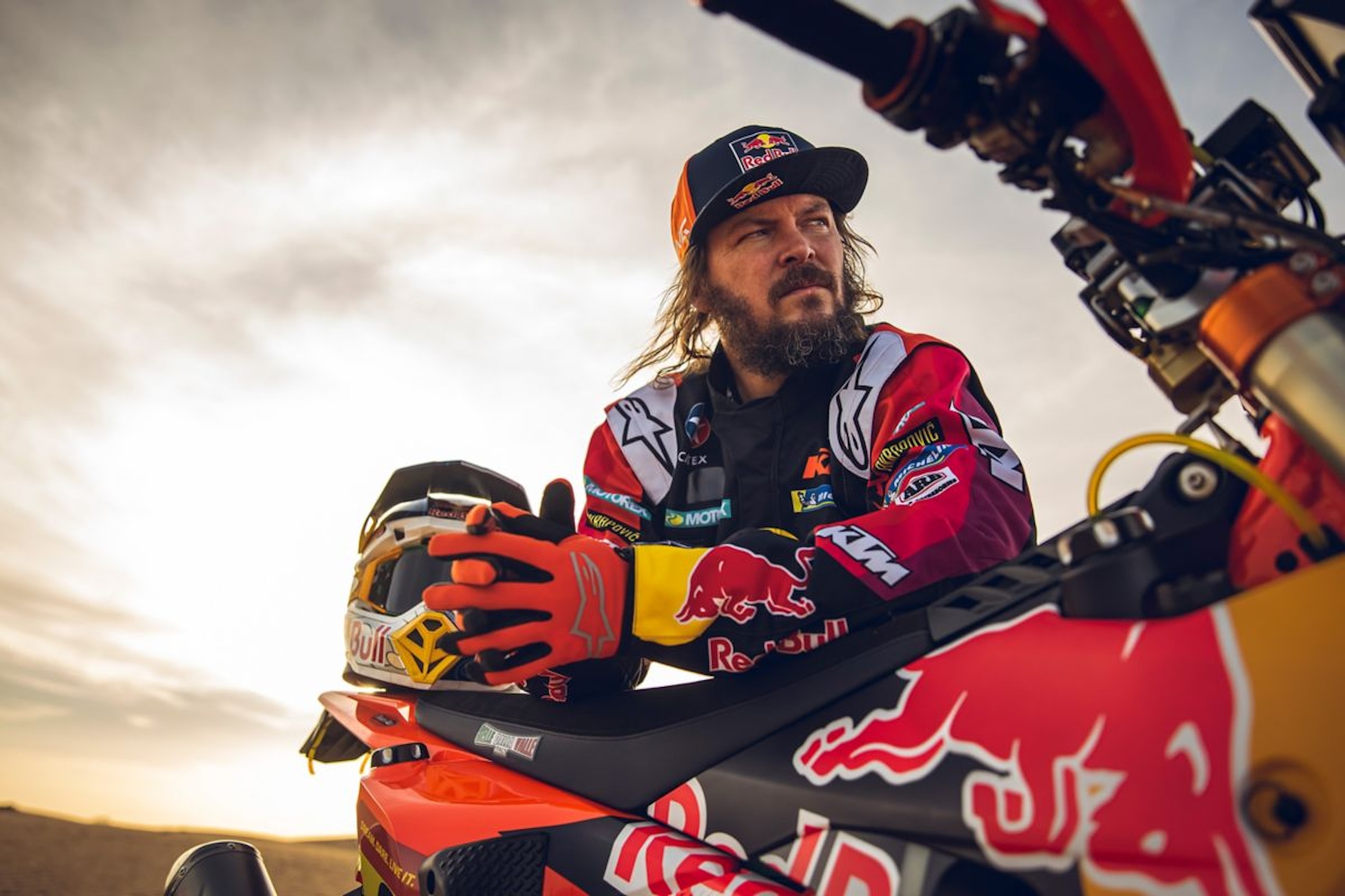 A rally racer with his motorcycle.