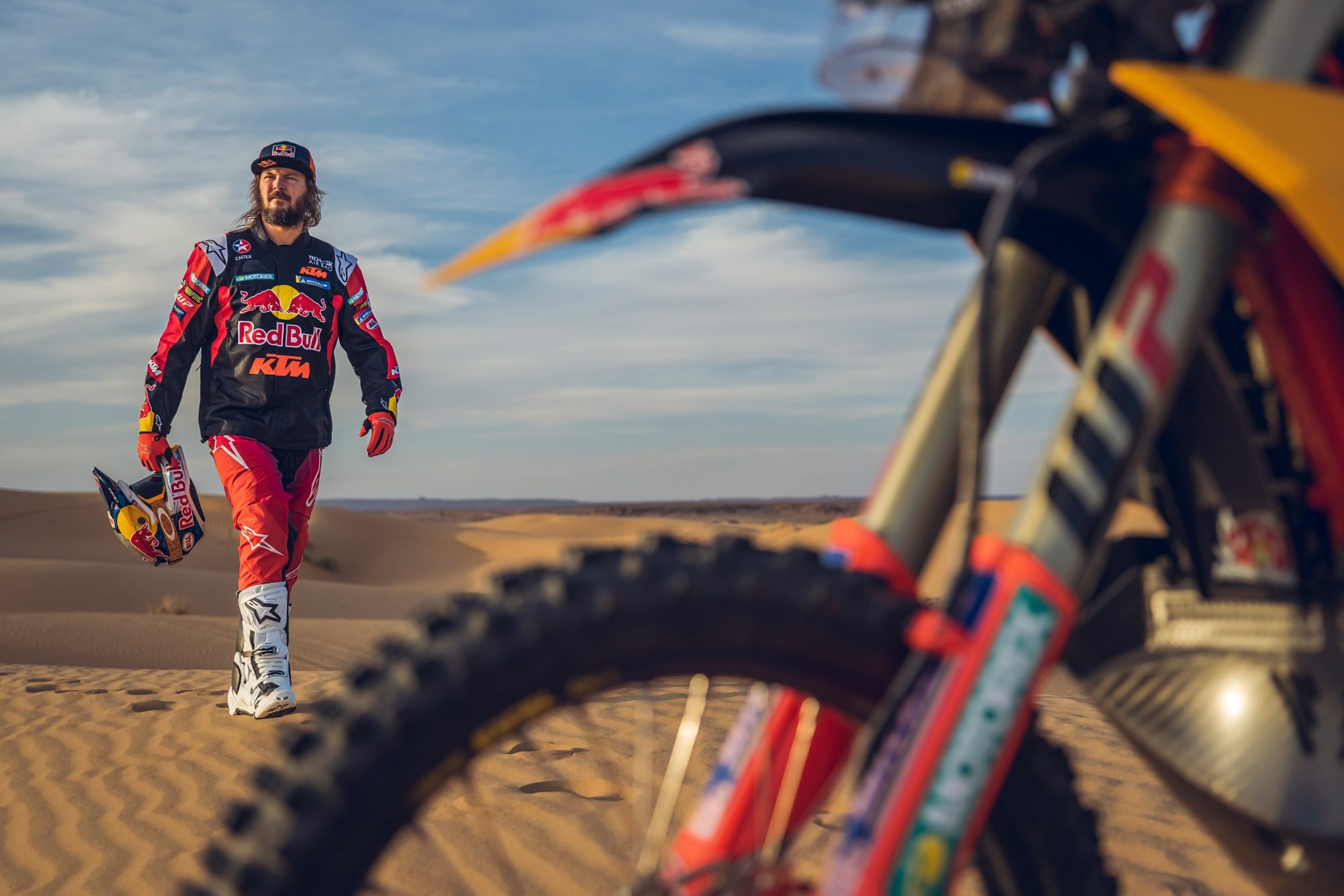 A rally racer in the sand dunes.