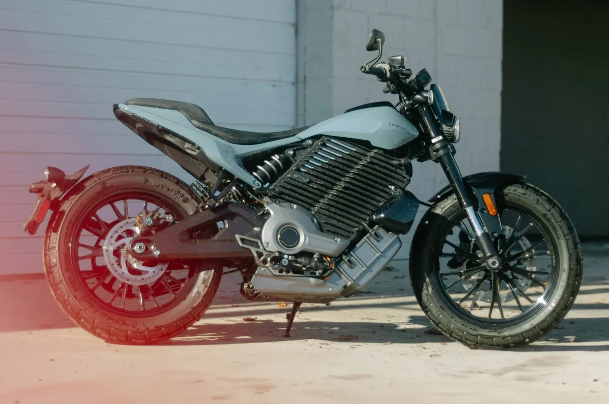 An electric motorcycle in front of a garage.