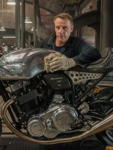 A man with a motorcycle.