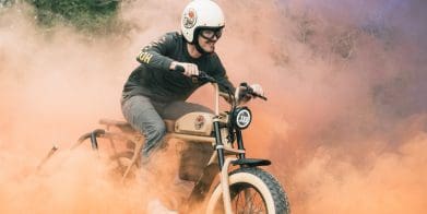 A guy riding an electric motorcycle.