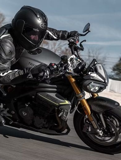 A motorcyclist leaning into a turn.