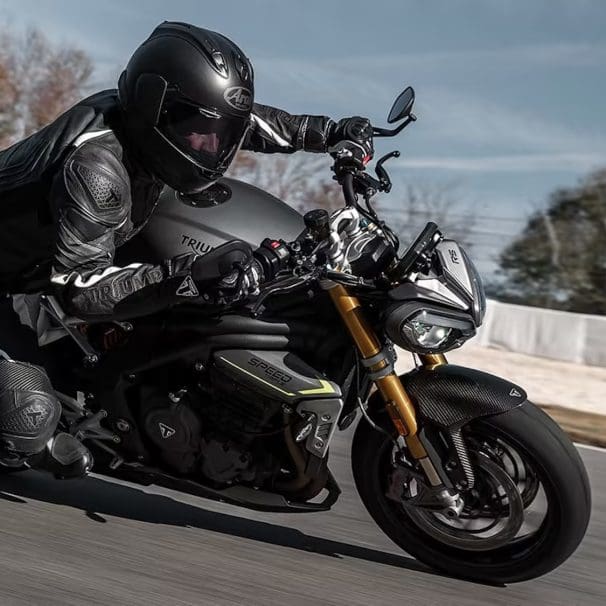 A motorcyclist leaning into a turn.