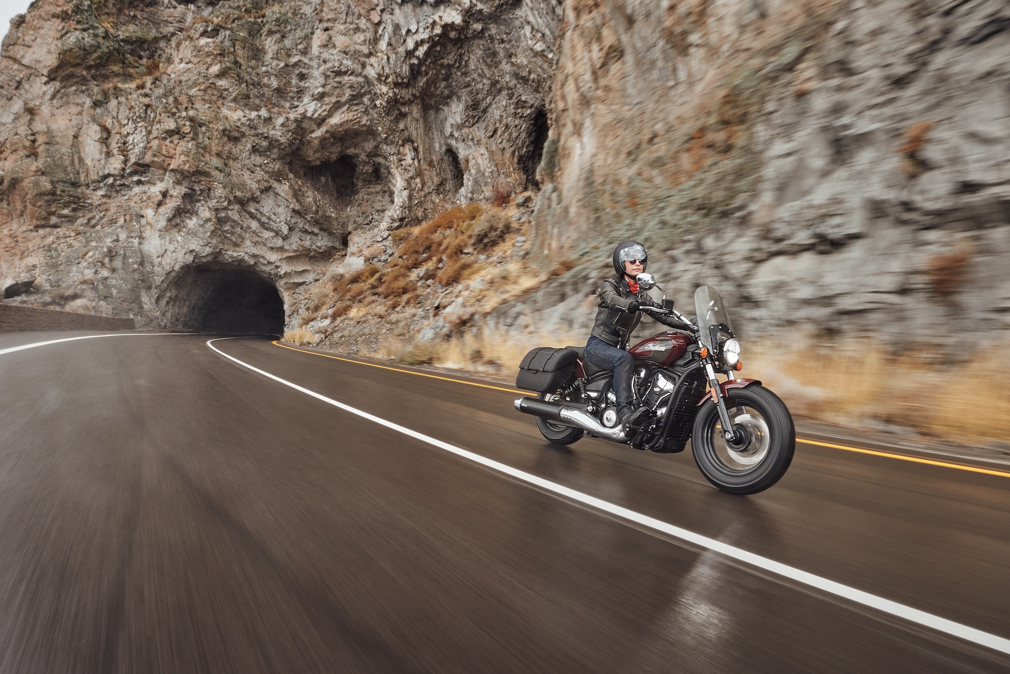 A man riding a motorcycle on a rainy day.