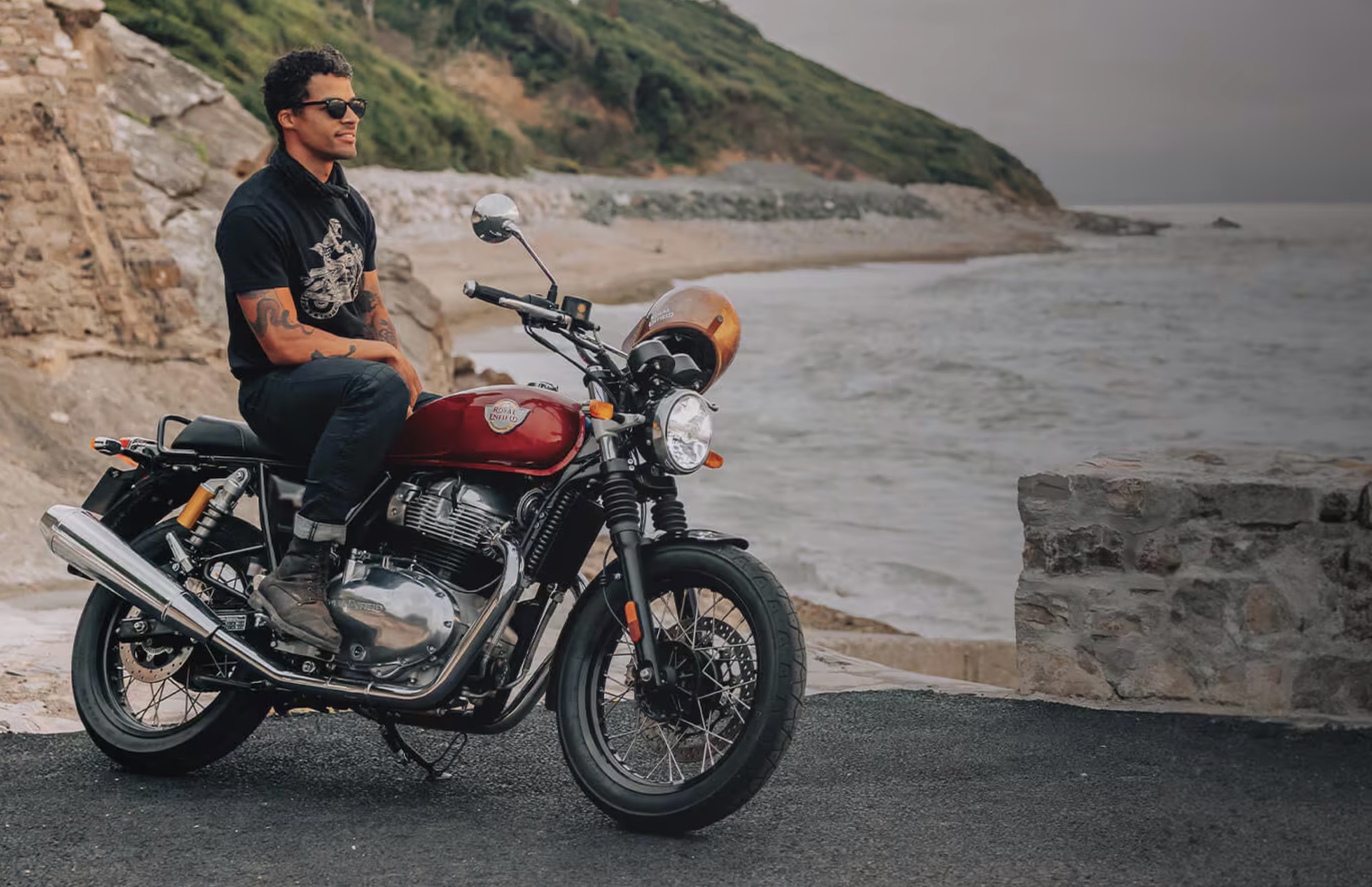 A man sitting on a Royal Enfield bike.