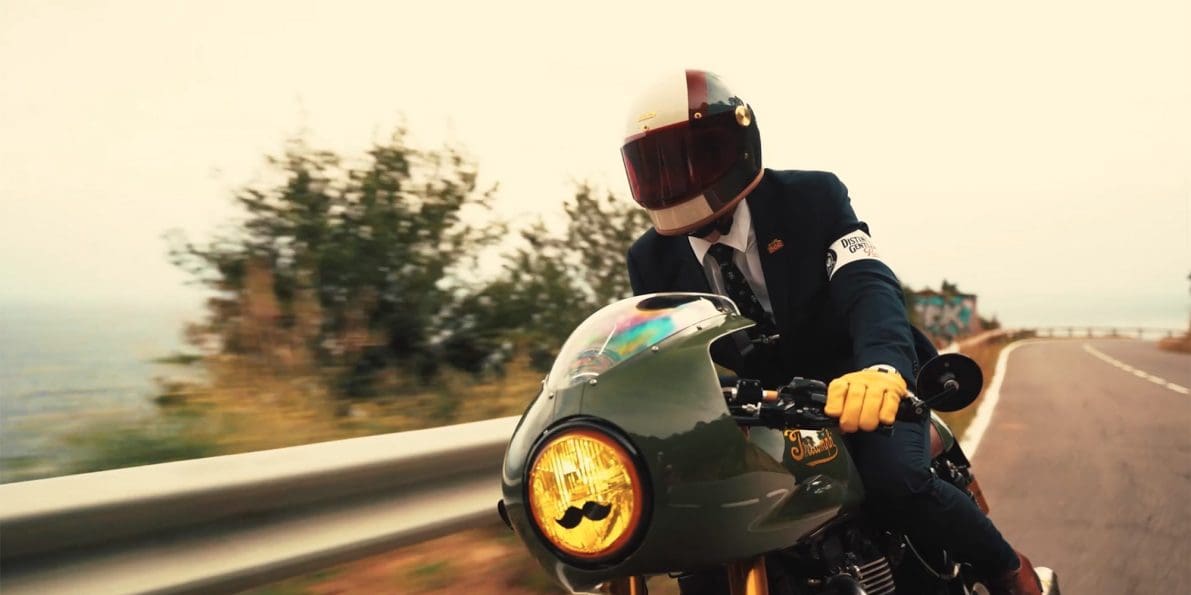 A view of a dapper-dressed gentleman riding for a cause with the Distinguished Gentleman's Ride.