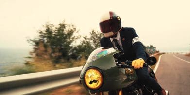 A view of a dapper-dressed gentleman riding for a cause with the Distinguished Gentleman's Ride.