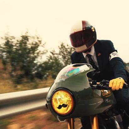 A view of a dapper-dressed gentleman riding for a cause with the Distinguished Gentleman's Ride.