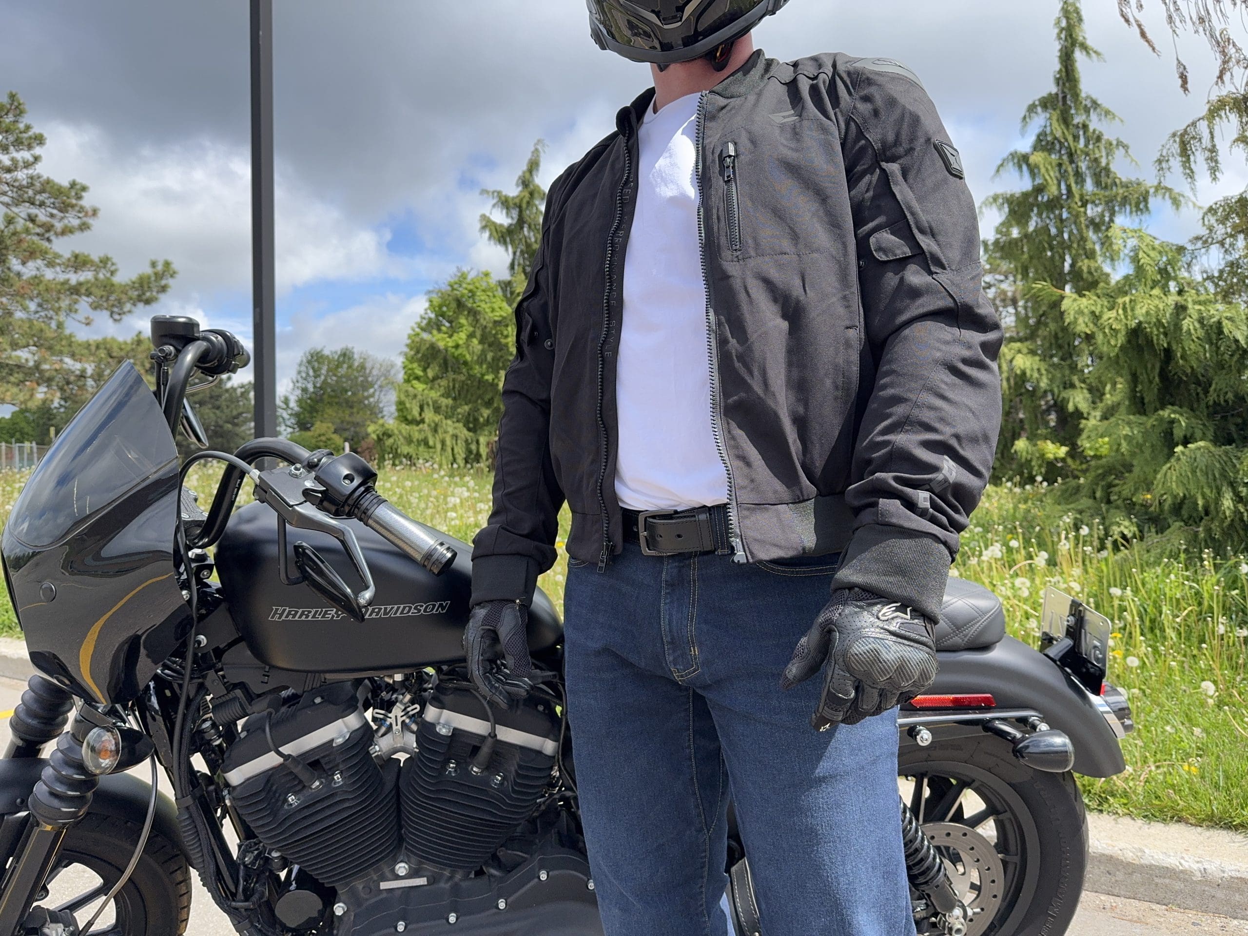 Rider standing in front of a Harley Davidson wearing the Cortech Versa-Flo Jacket with the zipper open