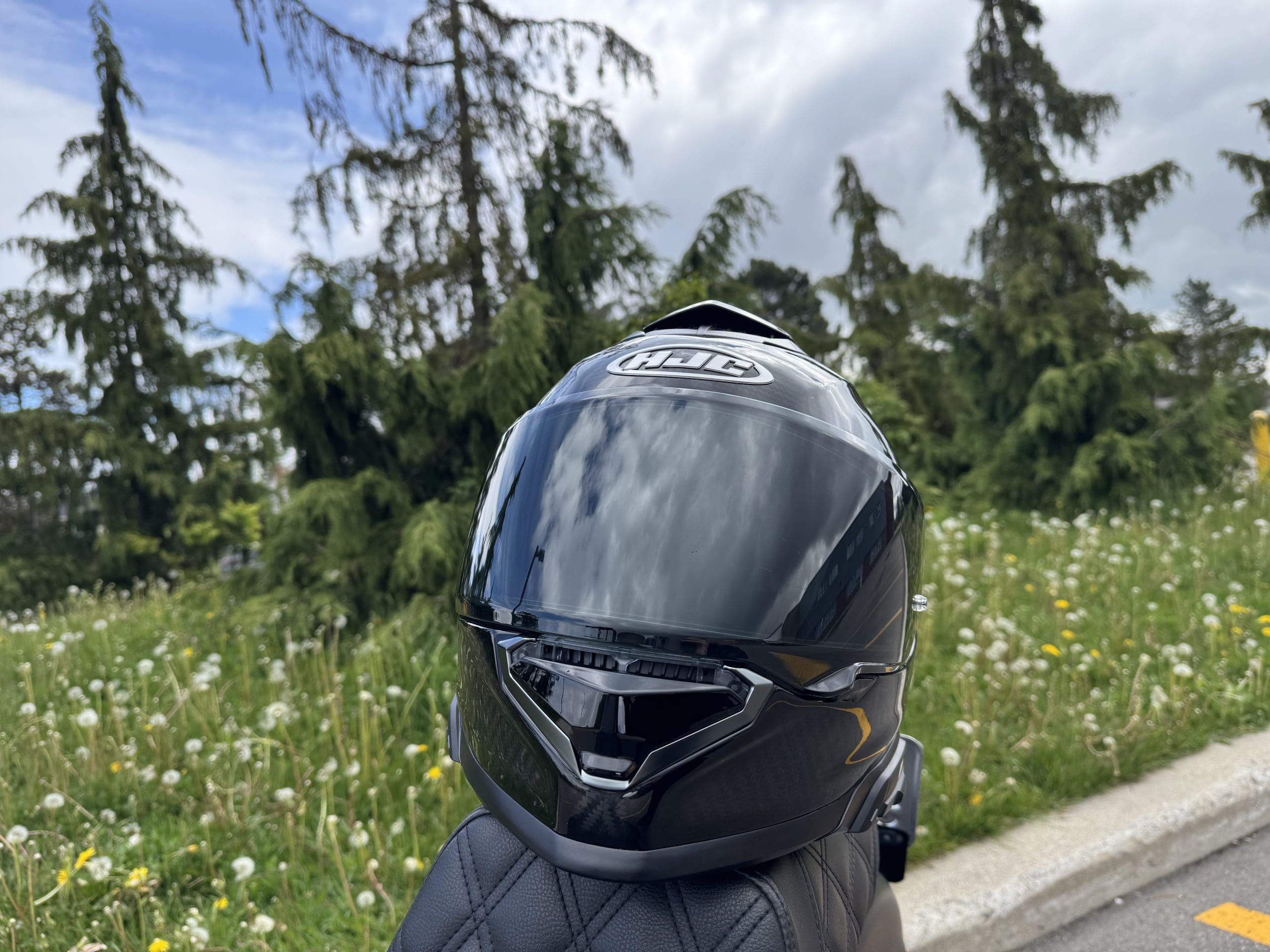 HJC RPHA 71 Carbon Helmet resting on a motorcycle seat
